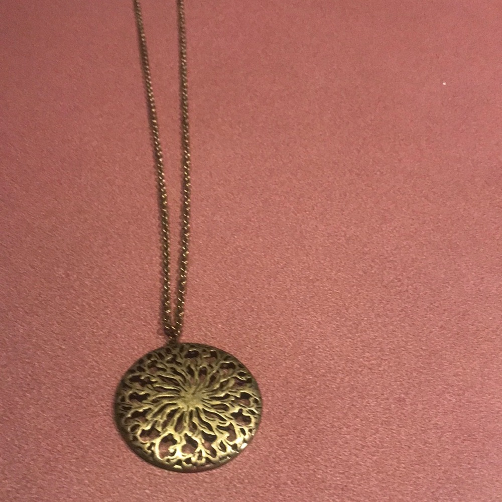 Brass tone long chain necklace with a round medallion pendant